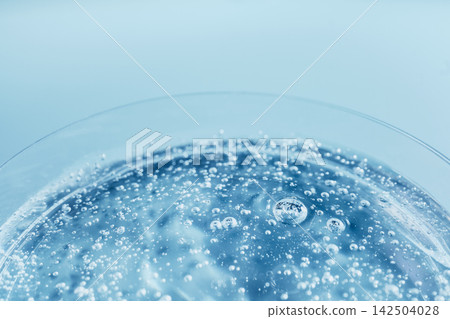Bubbles rising in sparkling blue liquid, forming an abstract and refreshing background Bubbles rising in sparkling blue liquid, forming an abstract and refreshing background 142504028