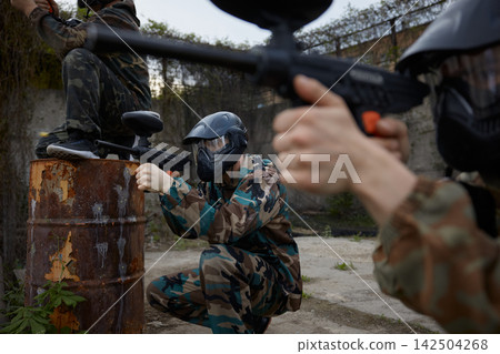 Soldiers take defensive positions and preparing for the attack during paintball tactical training Soldiers take defensive positions and preparing for the attack during paintball tactical training 142504268