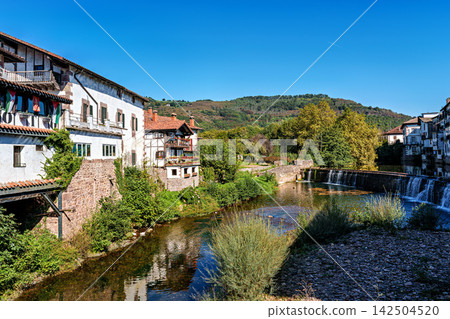 Walking through the streets of Elizondo, Navarra, Spain. Traditional Basque houses with classic red and white facades Walking through the streets of Elizondo, Navarra, Spain. Traditional Basque houses with classic red and white facades 142504520