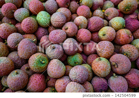 Lychee fruits with colorful rough skin texture. Lychee fruits with colorful rough skin texture. 142504599