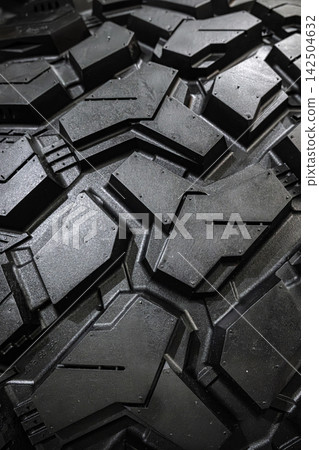 Black tire tread texture background with detailed rubber pattern. Black tire tread texture background with detailed rubber pattern. 142504632