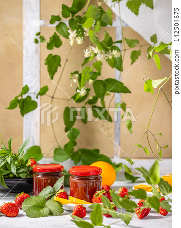 Jars of strawberry jam with fresh strawberries and orange slices Jars of strawberry jam with fresh strawberries and orange slices 142504875