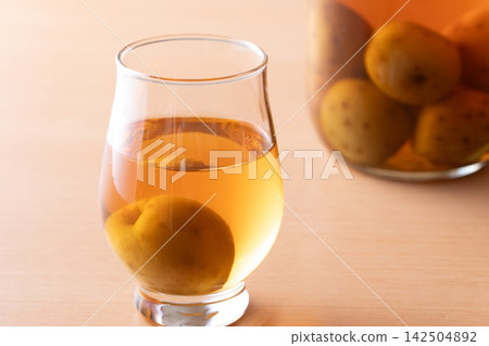 Drink plum wine from a glass. Drink plum wine from a glass. 142504892