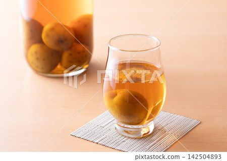 Drink plum wine from a glass. Drink plum wine from a glass. 142504893