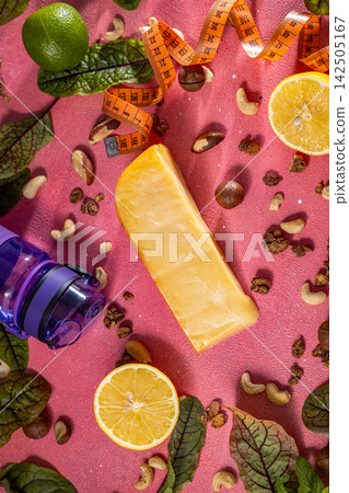 Healthy lifestyle concept featuring cheese, nuts, fruits, vegetables and a measuring tape Healthy lifestyle concept featuring cheese, nuts, fruits, vegetables and a measuring tape 142505167