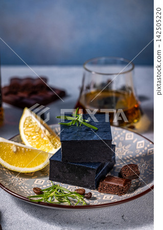 Black cheese with lemon, rosemary, coffee beans, aerated chocolate and glass of whisky Black cheese with lemon, rosemary, coffee beans, aerated chocolate and glass of whisky 142505220