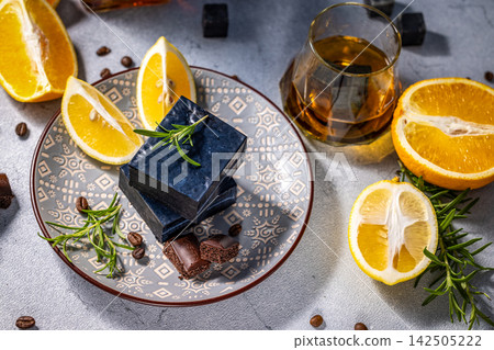 Black cheese, lemon slices, rosemary, and chocolate Black cheese, lemon slices, rosemary, and chocolate 142505222