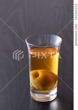 用玻璃杯喝梅子酒。 142505233