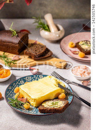 Delicious butter with rye bread and berries on rustic table setting Delicious butter with rye bread and berries on rustic table setting 142505746
