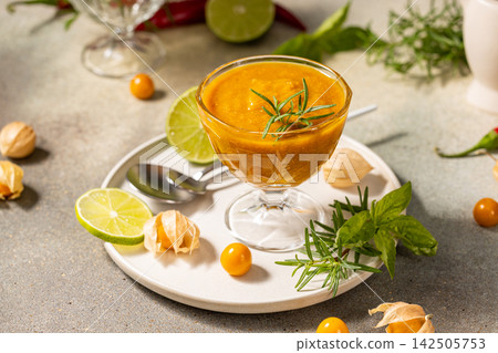 Delicious cape gooseberry sauce with lime and rosemary on a table Delicious cape gooseberry sauce with lime and rosemary on a table 142505753