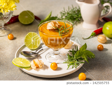 Delicious cape gooseberry sauce decorated with rosemary and lime slices Delicious cape gooseberry sauce decorated with rosemary and lime slices 142505755
