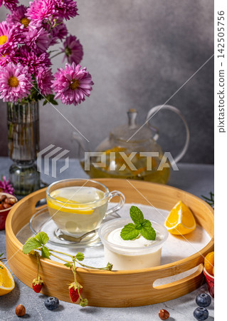 Relaxing tea time with yogurt and fresh fruits on wooden tray Relaxing tea time with yogurt and fresh fruits on wooden tray 142505756