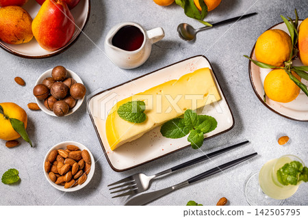 Gourmet cheese platter with fruits, nuts, and wine on table setting Gourmet cheese platter with fruits, nuts, and wine on table setting 142505795