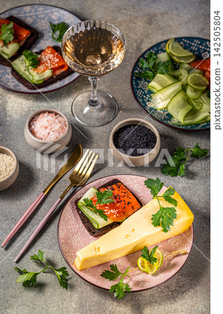 Gourmet lunch with smoked salmon, cheese, cucumber sandwiches and white wine Gourmet lunch with smoked salmon, cheese, cucumber sandwiches and white wine 142505804