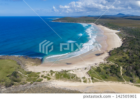 Aerial view of Angourie Point and Angourie Back Beach, showing the rugged rocky headland, sandy shoreline, Pacific Ocean and surrounding coastal landscape at Angourie on the NSW North Coast, Aerial view of Angourie Point and Angourie Back Beach, showing the rugged rocky headland, sandy shoreline, Pacific Ocean and surrounding coastal landscape at Angourie on the NSW North Coast, 142505901