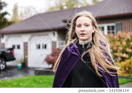 Young Woman Wearing Purple Cape for Halloween Young Woman Wearing Purple Cape for Halloween 142506154