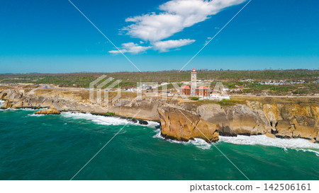 Aerial View of Cabo Mondego Lighthouse Above Rugged Atlantic Cliffs Aerial View of Cabo Mondego Lighthouse Above Rugged Atlantic Cliffs 142506161