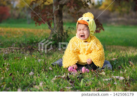 Crying Toddler in Yellow Duck Costume on Halloween Crying Toddler in Yellow Duck Costume on Halloween 142506179