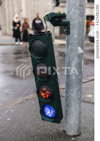 Damaged Bicycle Traffic Light on Wet Street Damaged Bicycle Traffic Light on Wet Street 142506206