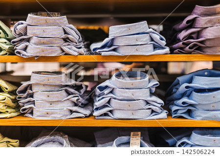 Neatly Folded Shirts on Wooden Retail Shelves Neatly Folded Shirts on Wooden Retail Shelves 142506224