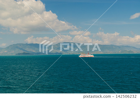 Passenger Ferry Crossing Before Mountainous Coastline 142506232