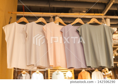 Pastel Sleeveless Tops on Wooden Hangers Pastel Sleeveless Tops on Wooden Hangers 142506290