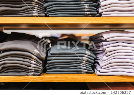 Neatly Folded Shirts on Wooden Retail Shelves Neatly Folded Shirts on Wooden Retail Shelves 142506297