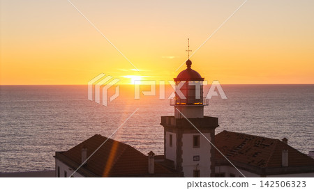 Cabo Mondego Lighthouse Silhouetted at Sunset 142506323