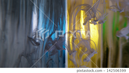 Ink flow. Fog wave. Blur yellow blue green colorful water fluid swirling acrylic creative smoke spreading on abstract art background. Ink flow. Fog wave. Blur yellow blue green colorful water fluid swirling acrylic creative smoke spreading on abstract art background. 142506399