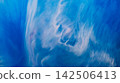 Paint particles. Marble wave. Defocused blue white color ink in water liquid flow emulsion splash spreading on abstract art background. 142506413