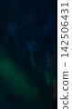 Defocused gleam glimmer. Radiant light. Blur blue green color glisten luminous visual flash on abstract bokeh art dark black background. 142506431