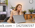 Businesswoman ends dull shift closes laptop with sharp motion waves hand bored and annoyed by task 142506597