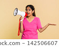 Indian woman energetically speaking into megaphone, making announcement or calling with excitement 142506607
