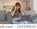 Young woman with laptop rubs temples headache pause closes eyes tired takes break for relief needed 142506610
