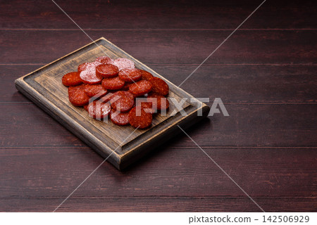 Slices of smoked pepperoni or salami for making homemade pizza. Sliced pepperoni Slices of smoked pepperoni or salami for making homemade pizza. Sliced pepperoni 142506929