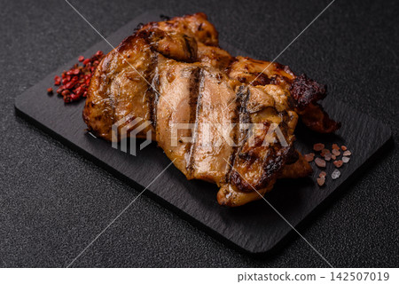 Grilled chicken breast seasoned with salt and spices. Grilled chicken Grilled chicken breast seasoned with salt and spices. Grilled chicken 142507019