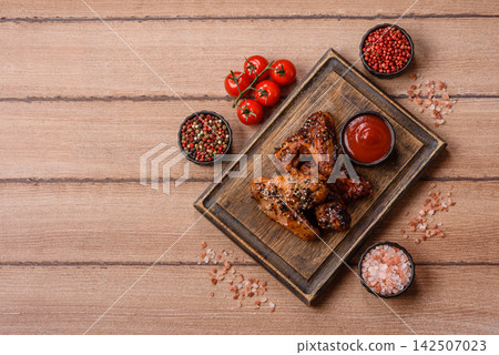 Grilled chicken wings with teriyaki sauce, seasoned with salt and spices. Chicken wings Grilled chicken wings with teriyaki sauce, seasoned with salt and spices. Chicken wings 142507023