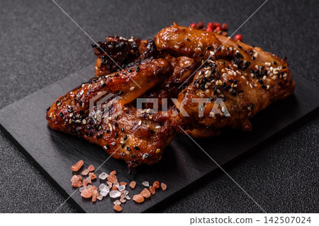Grilled chicken wings with teriyaki sauce, seasoned with salt and spices. Chicken wings Grilled chicken wings with teriyaki sauce, seasoned with salt and spices. Chicken wings 142507024