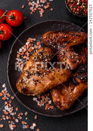 Grilled chicken wings with teriyaki sauce, seasoned with salt and spices. Chicken wings Grilled chicken wings with teriyaki sauce, seasoned with salt and spices. Chicken wings 142507025
