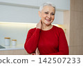 Portrait of confident stylish European middle aged senior woman. Older mature 60s lady smiling at home. Happy attractive senior female looking camera close up face headshot portrait. Happy people 142507233