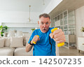 Fitness workout training. Senior man boxing punching picking up dumbbells. Old adult mature healthy man doing sports exercise at home. Grandfather have workout rehabilitation. Health care healthy 142507235