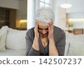 Sad tired ill sick lonely disappointed older senior woman sitting at home alone. Unhappy mature grandmother experiencing grief relative death bad news. Stressed elder lady suffering from loneliness 142507237