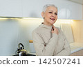Portrait of confident stylish European middle aged senior woman. Older mature 60s lady smiling at home. Happy attractive senior female looking camera close up face headshot portrait. Happy people 142507241
