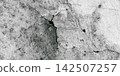 Cracked gray concrete wall with spider web-like cracks. 142507257