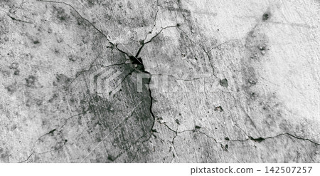 Cracked gray concrete wall with spider web-like cracks. Cracked gray concrete wall with spider web-like cracks. 142507257