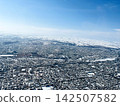Aerial view of a snow-covered city in Hokkaido. 142507582
