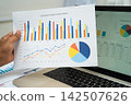 Asian business woman working with financial graph. 142507626