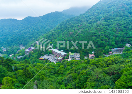 A hotel in Yunoyama Onsen, Mie Prefecture, nestled against the mountainside as seen from the ropeway. A hotel in Yunoyama Onsen, Mie Prefecture, nestled against the mountainside as seen from the ropeway. 142508303