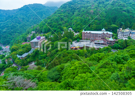 A hotel in Yunoyama Onsen, Mie Prefecture, nestled against the mountainside as seen from the ropeway. A hotel in Yunoyama Onsen, Mie Prefecture, nestled against the mountainside as seen from the ropeway. 142508305