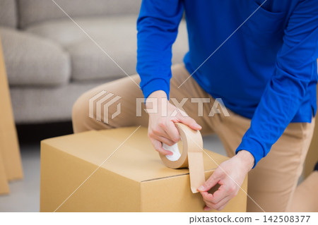 Worker with cardboard box Worker with cardboard box 142508377